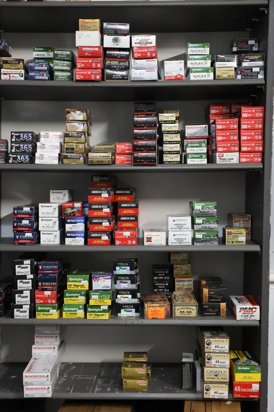 Shelves stocked with boxes of handgun and rifle ammunition