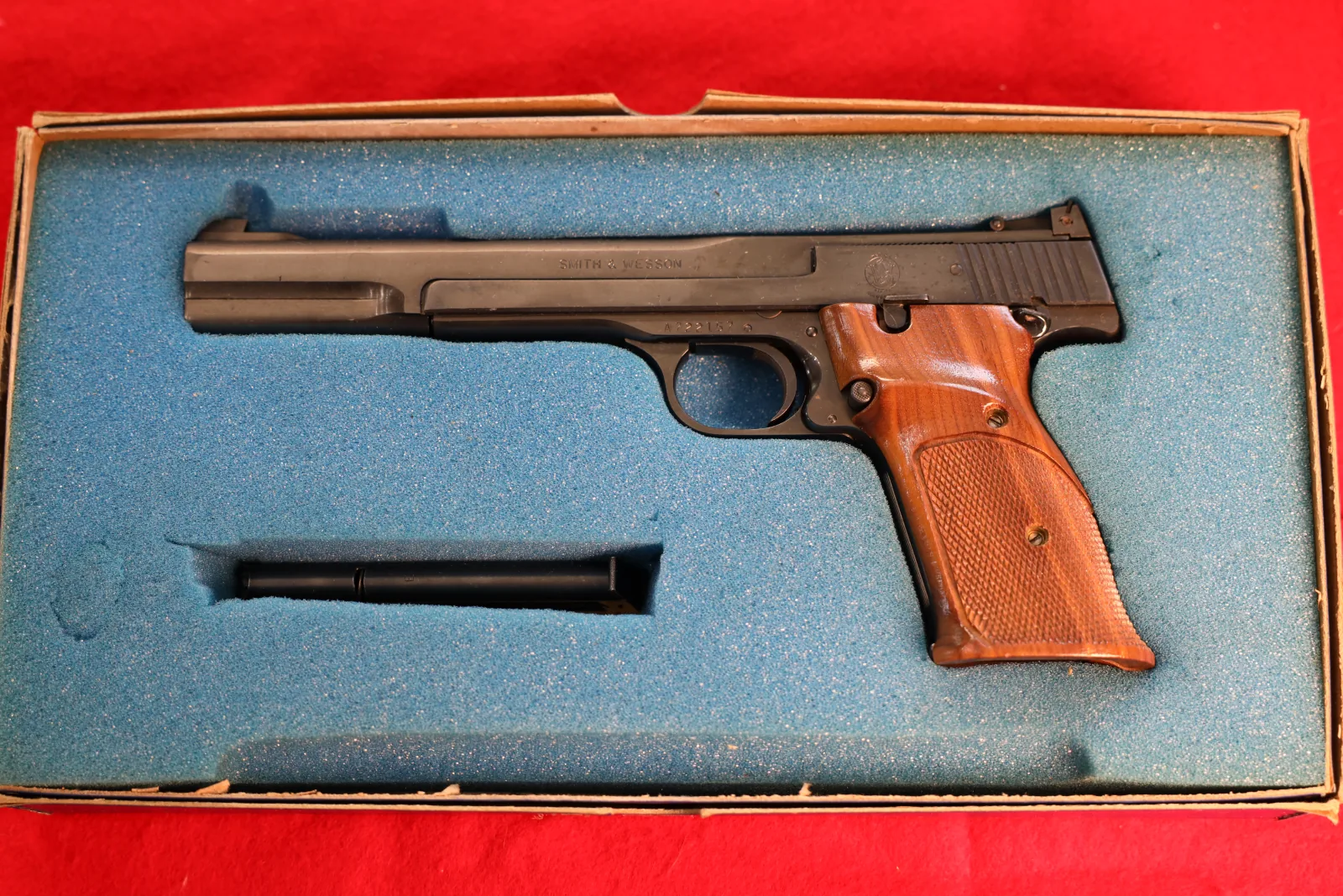 Vintage target pistol with wood grips in its original box