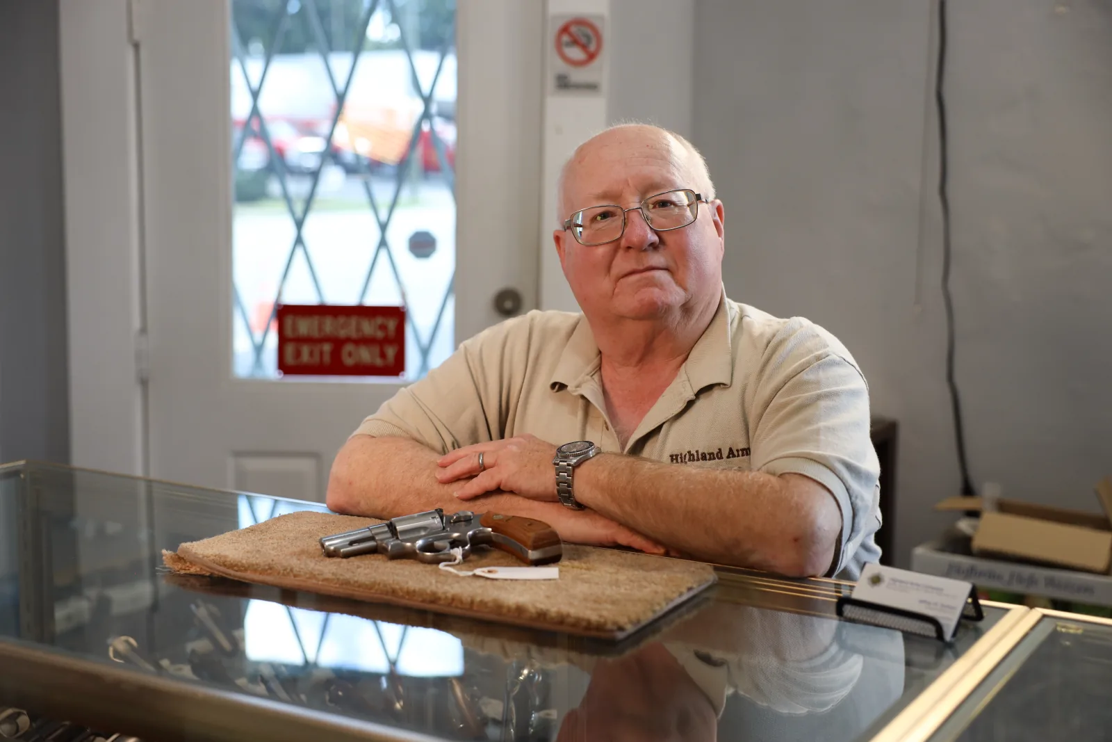 Jeffrey W. Graham, owner of Highland Arms Co, leaning on the shop counter